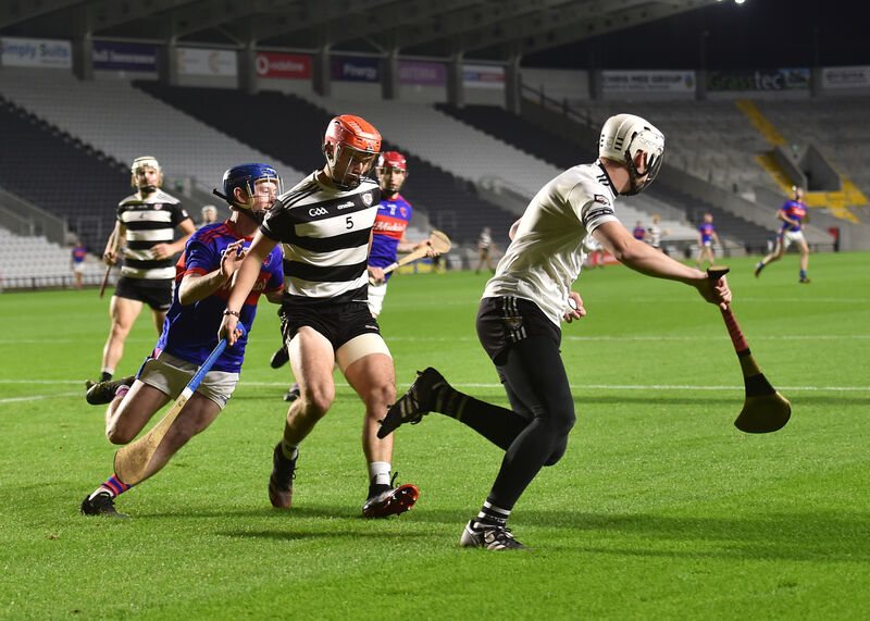 Midleton keeper Brian Saunderson breaks out of defence while Ciarmhac Smyth holds back Erin's Own's Cian O'Callaghan. Picture: Dan Linehan