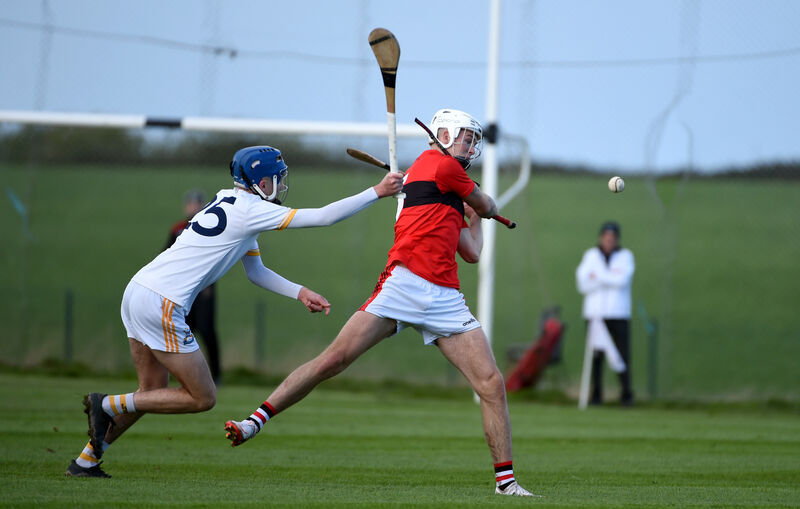  Cloyne full-back Adam Sherlock makes a clearance under pressure from Rory Desmond, Bandon. Picture: Larry Cummins.