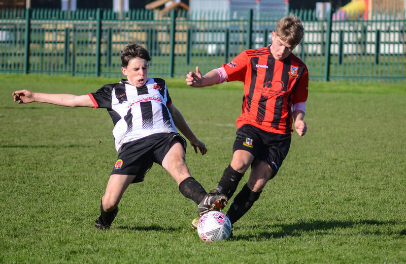 Midleton's Rory Black manages to get a foot to the ball as Ringmahon Rangers Adam O'Callaghan surges forward during the CSL U16 National Cup game at Knockgriffin Park. Picture: Howard Crowdy