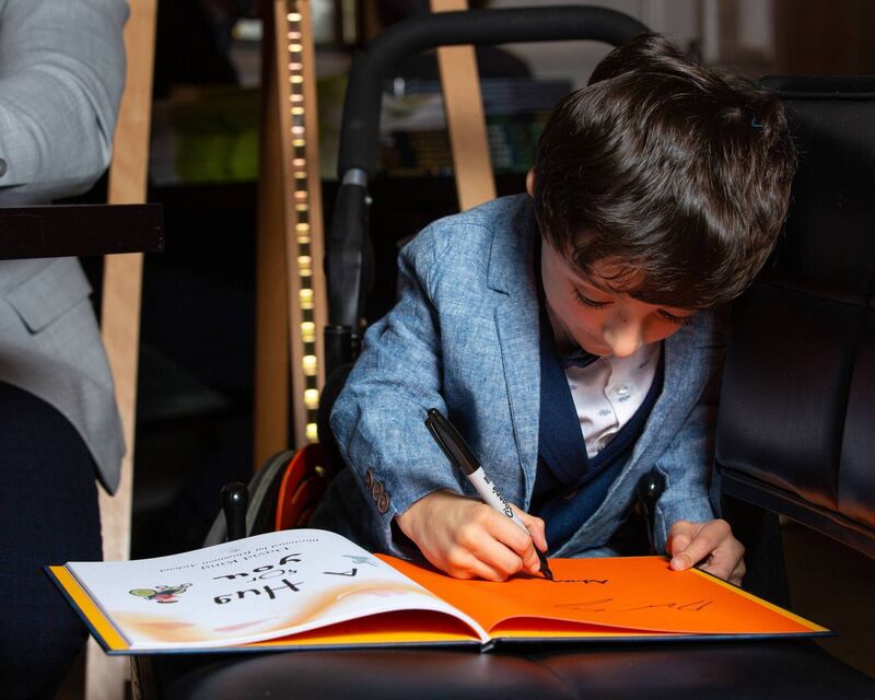 Adam King signing book 'A Hug For You' written by Dad, David King. Photo by: Shaunagh O'Connell Adam King signing book 'A Hug For You' written by Dad, David King. Photo by: Shaunagh O'Connell