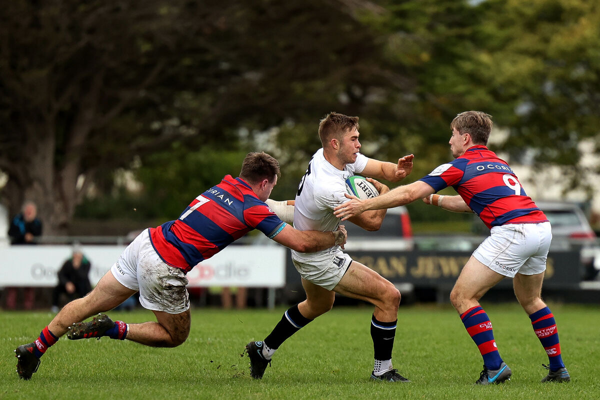  Cork Con's Jack Crowley fends off pressure from Clontarf's Angus Lloyd. Picture: Tommie Dickson