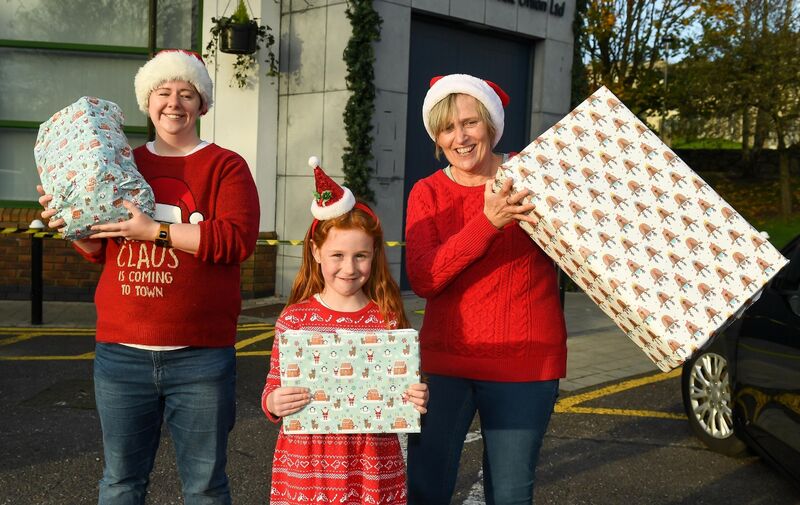  Volunteer Sarah Lynch, left with organiser Chris Mulcahy and Faye Mulcahy, enjoying the launch of the Toy Appeal Drive By in aid of local charities in Glanmire. Picture: David Keane