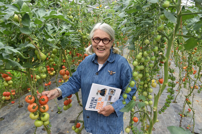  Darina Allen in the gardens of the Ballymaloe Cookery School with her 20th book How To Cook. Picture Dan Linehan