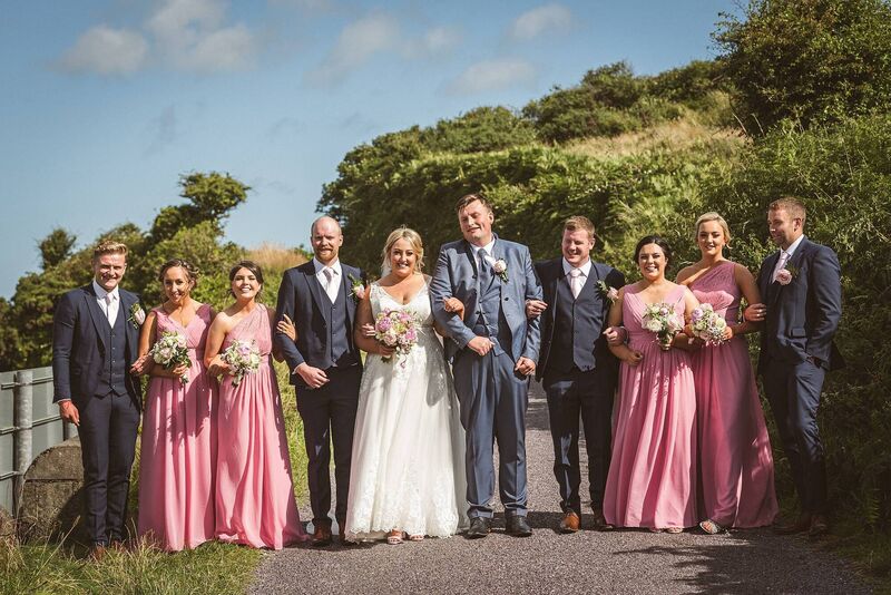 BY THEIR SIDE: The happy newlyweds with their bridal party, made up of family and friends.