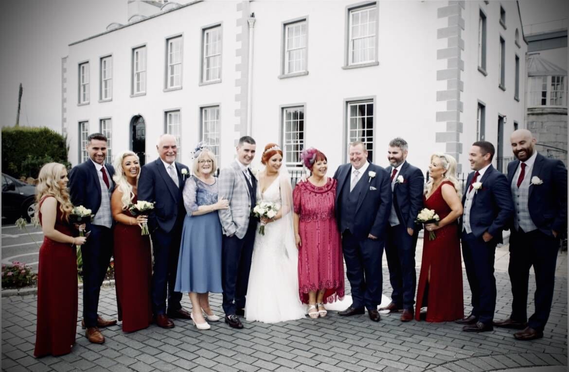 The happy couple with their parents and bridal party. Pictured left of the groom are his parents Danny and Celene Drennan.