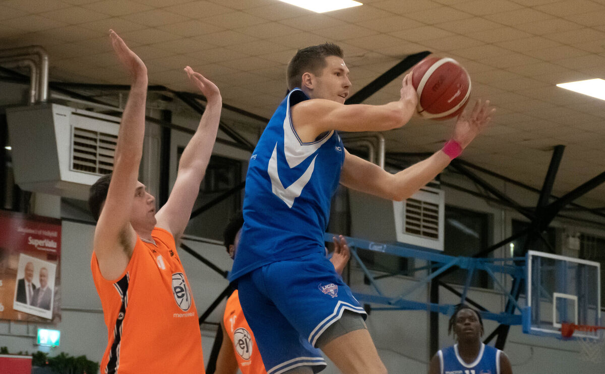 UCC Demons' Toby Christensen rises high to gather the ball ahead of EJ Sligo All-Stars Cian Lally at the Parochial Hall. Picture: Howard Crowdy