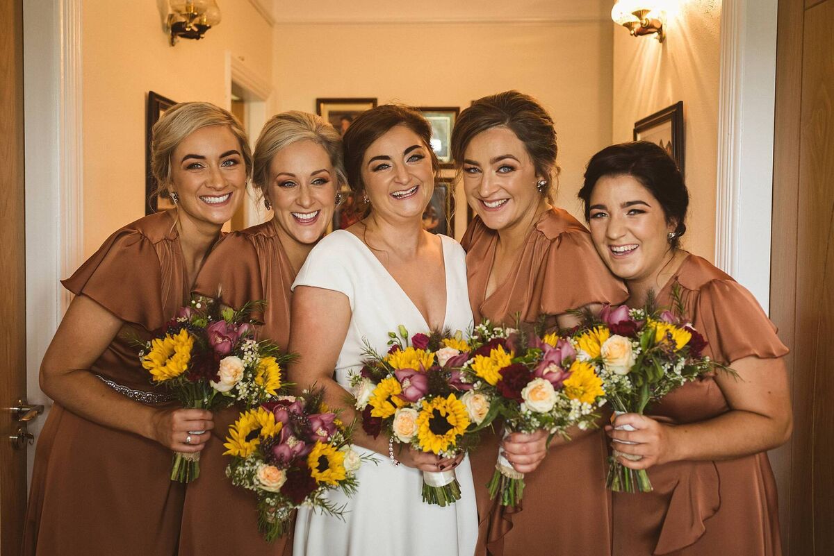 Sisters Karen Galvin, Elaine Kelly and Lynda Galvin and sister in law, Sinead O’ Connor were bridesmaids, they wore autumnal coloured, rust wrap dresses from Folkster, Kilkenny. Makeup was by Christine O’Connor, Ballincollig, hair was by Georgina Murray, Dunmanway. Sisters Karen Galvin, Elaine Kelly and Lynda Galvin and sister in law, Sinead O’ Connor were bridesmaids, they wore autumnal coloured, rust wrap dresses from Folkster, Kilkenny. Makeup was by Christine O’Connor, Ballincollig, hair was by Georgina Murray, Dunmanway.