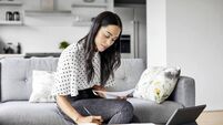 Woman analyzing documents while sitting at home