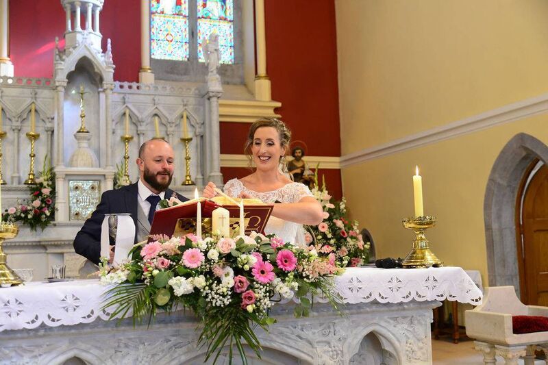 Brendan Whelan and Joanne O’Reilly lighting their candles. Flowers were by Bouquets by Victoria in Carrigaline.