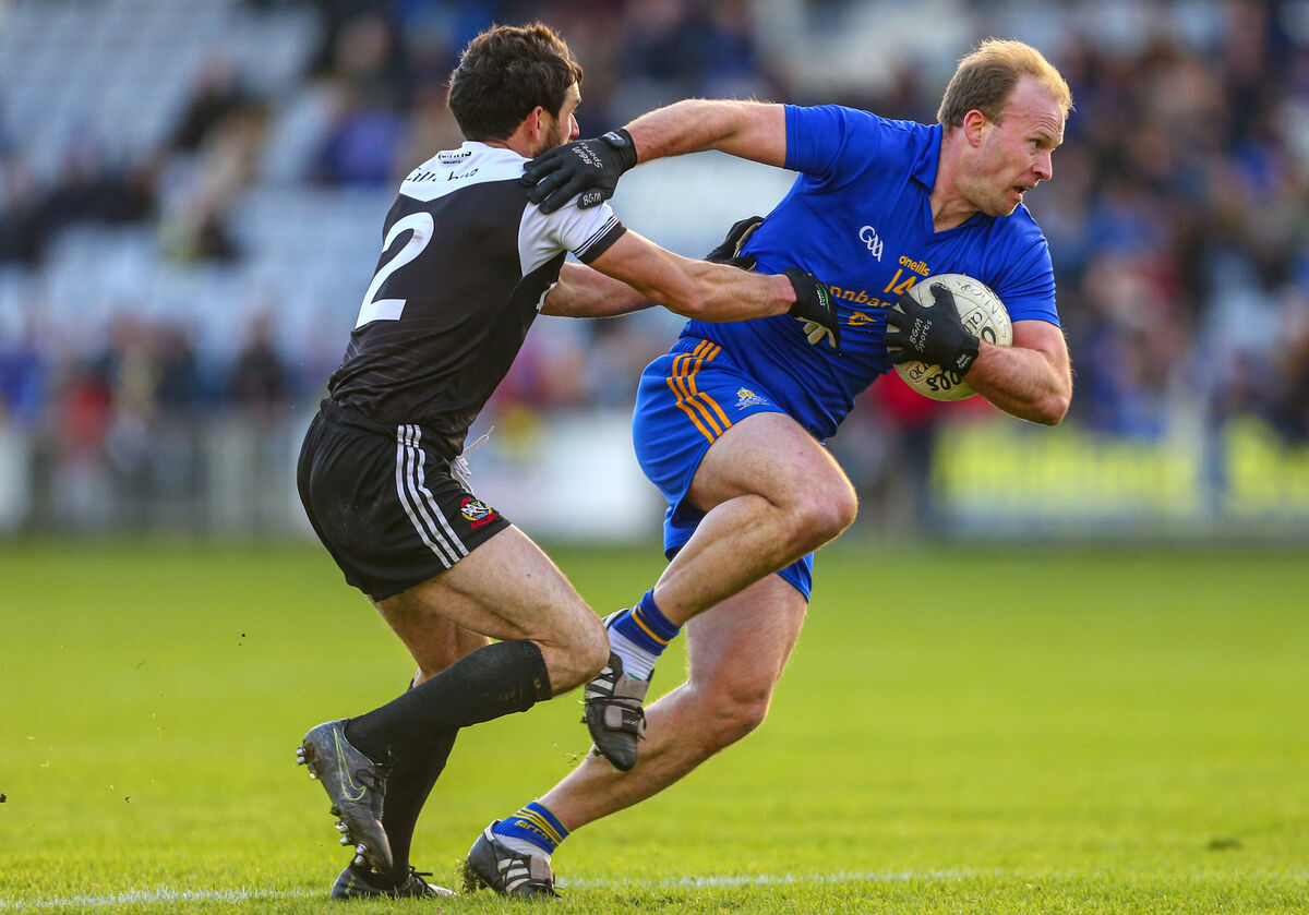 St Finbarr’s Micheal Shields gets by Kilcoo’s Niall Branagan. Picture: INPHO/Ken Sutton
