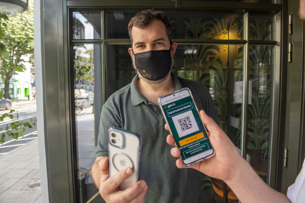 Ernest Cantillon getting his EU digital covid certificate checked by bar manager Carl Dalton the Electric bar & restaurantnt on the South Mall, Cork during covid restrictions. Picture Dan Linehan Ernest Cantillon getting his EU digital covid certificate checked by bar manager Carl Dalton the Electric bar & restaurantnt on the South Mall, Cork during covid restrictions. Picture Dan Linehan