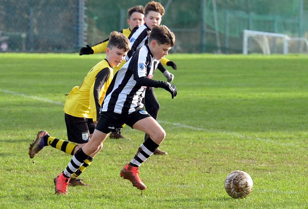 Rocky O'Callaghan of St. Mary's trying to get clear of Riverstown's Oliver Yelverton in the Blackwater Motors Under 12 Local Cup at St. Mary's Park. 