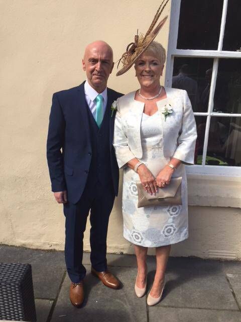 The happy couple attending a wedding.