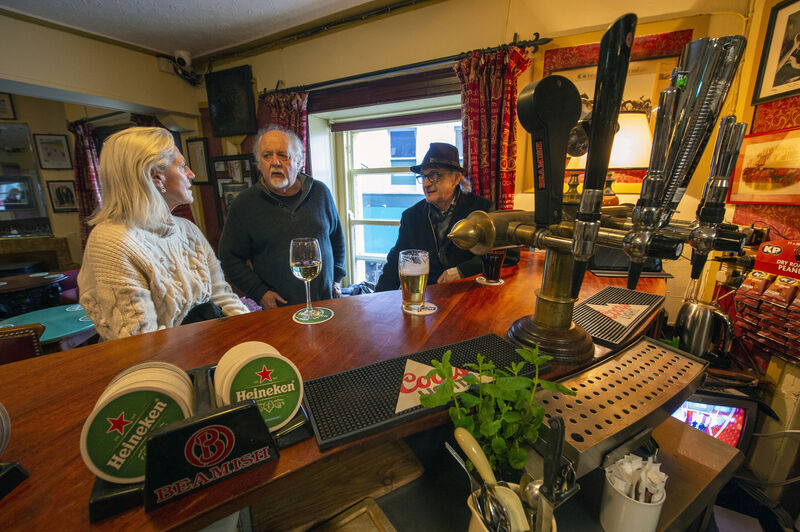  Hans Neff, Joe Moynihan and Lourdes Mackey enjoying a beverage. 