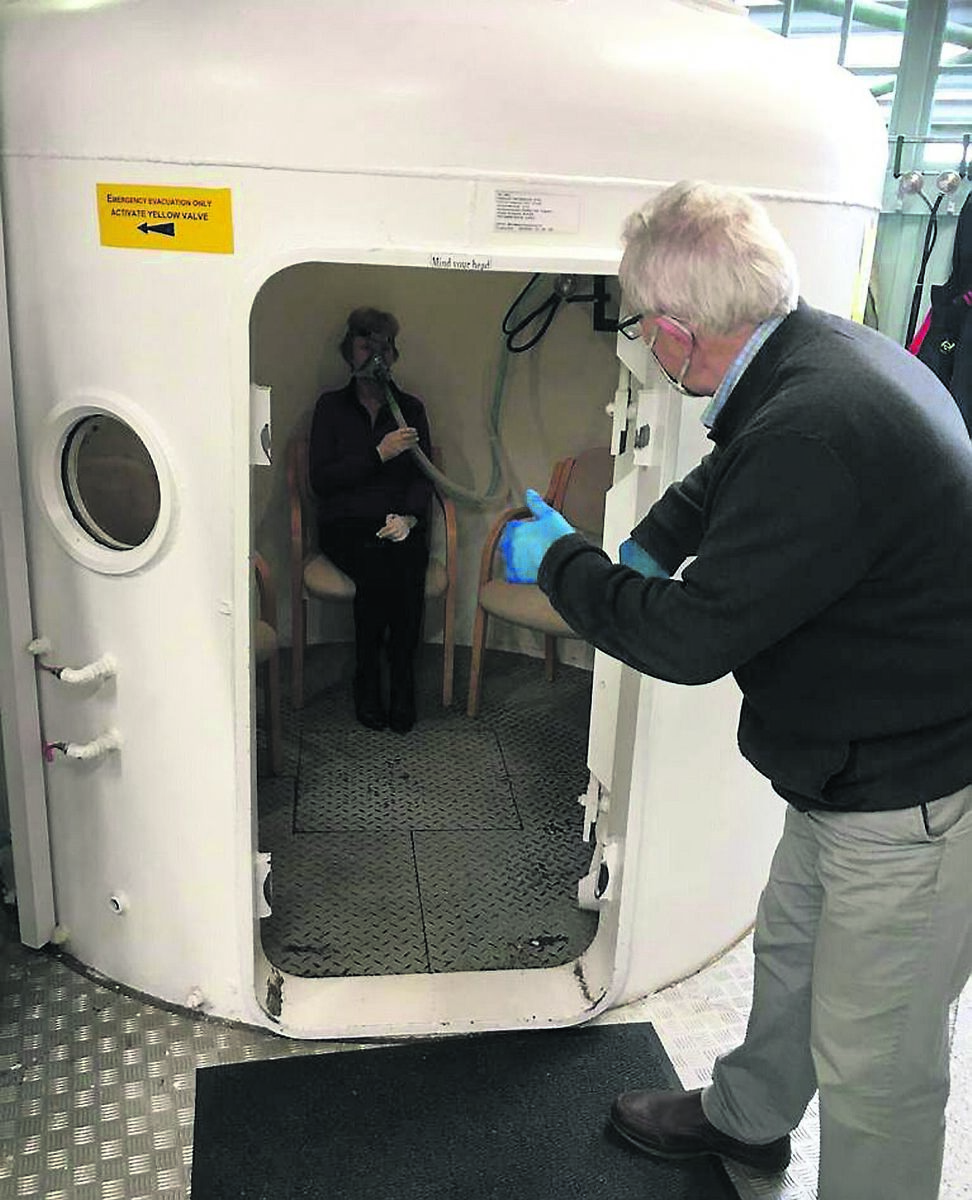 Volunteers Hilary Crowley and Margaret Wilmot demonstrate the treatment for Long Covid sufferers at the Hyperbaric Oxygen Centre in Bandon