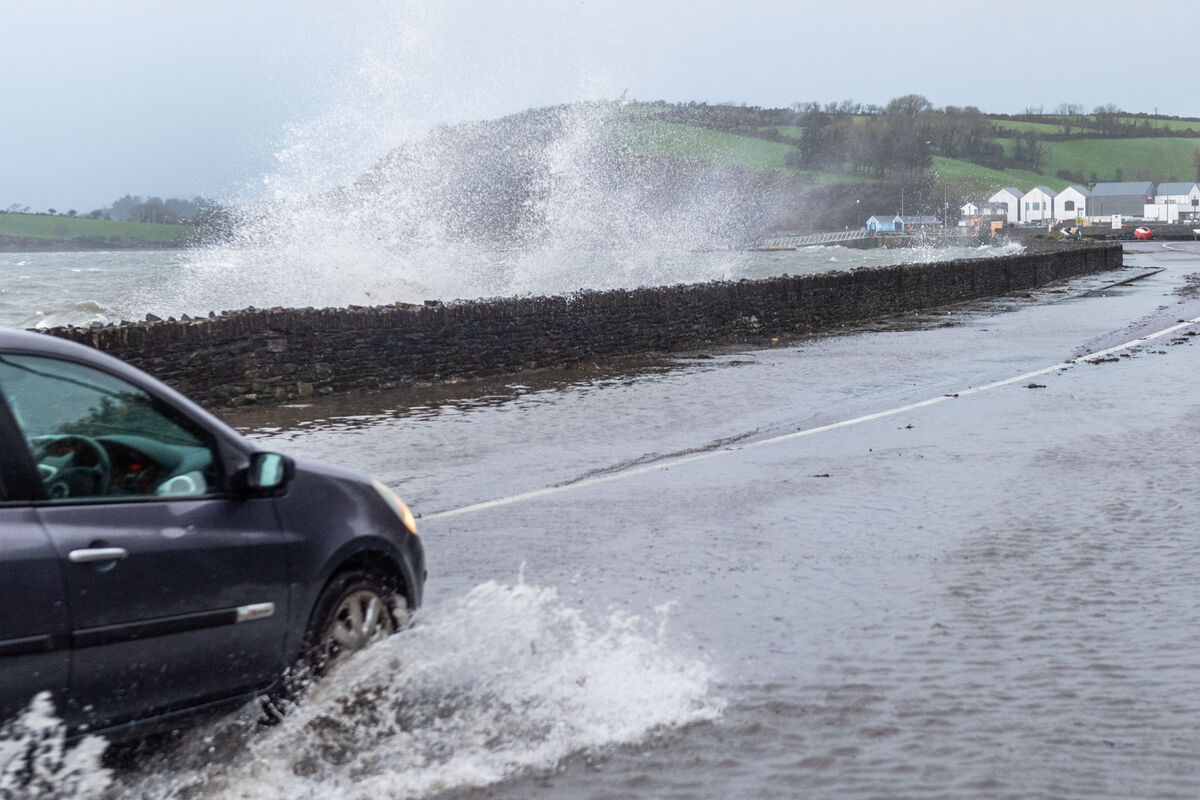 Cars negotiate flood waters on the N71 just outside Bantry this morning. Met Éireann's Red Weather Warning has been downgraded to a orange warning as high winds persist. Picture: Andy Gibson. Cars negotiate flood waters on the N71 just outside Bantry this morning. Met Éireann's Red Weather Warning has been downgraded to a orange warning as high winds persist. Picture: Andy Gibson.