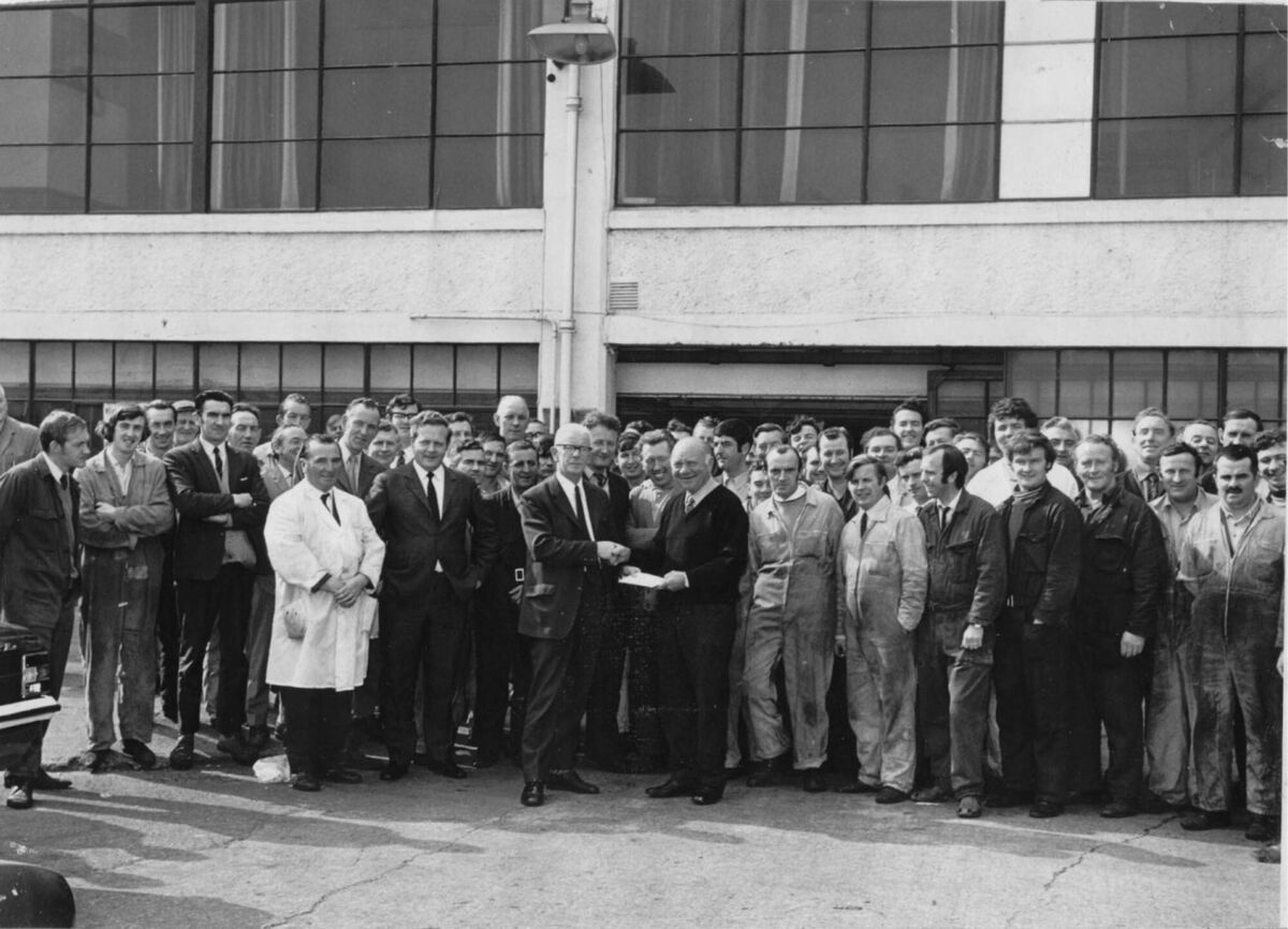 Irish soccer international Harry Buckle, father of Bobby an FAI Cup winner in 1934 and grandfather of dual star Dave Barry, receiving a presentation from his colleagues in Henry Ford's on his retirement.