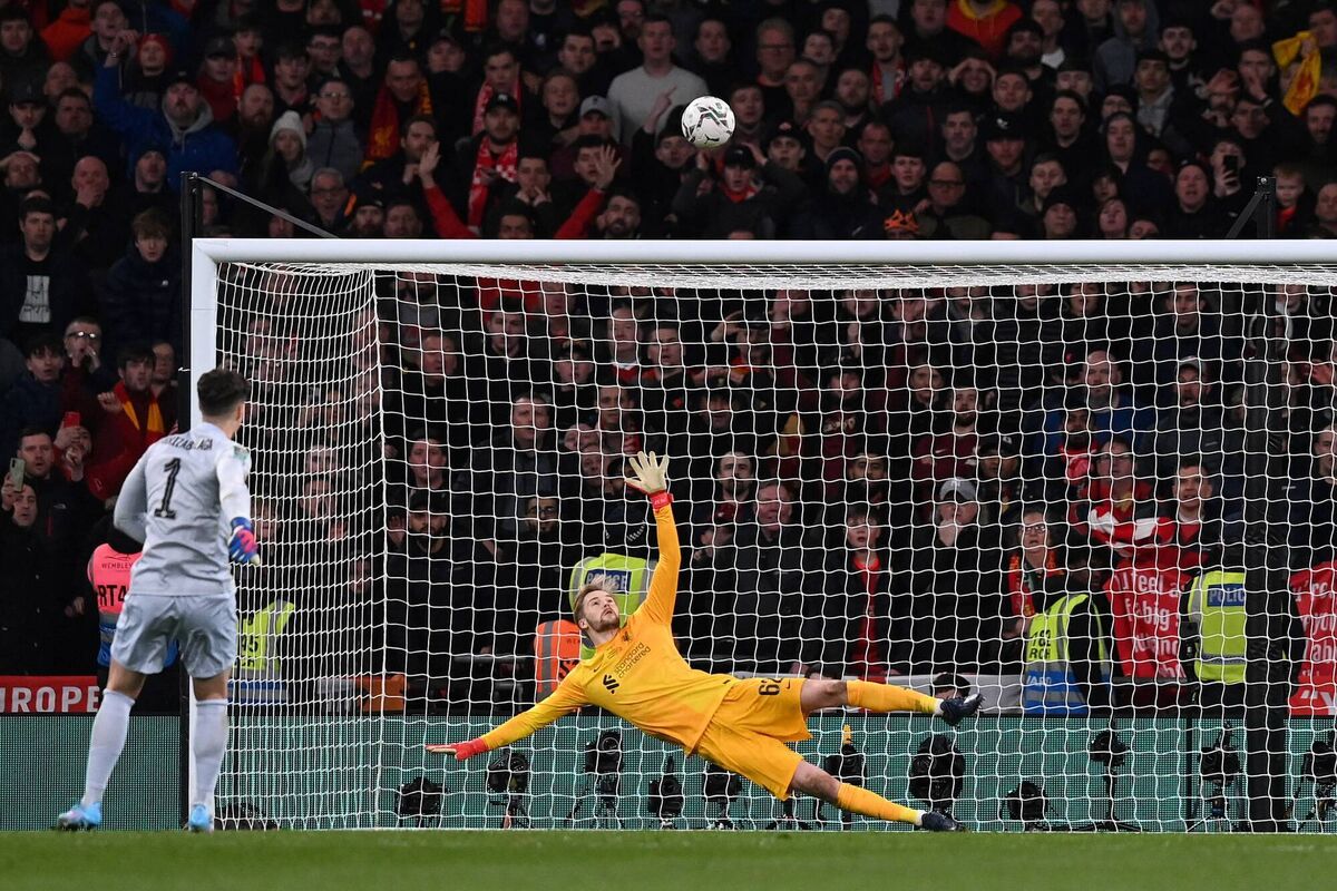 Liverpool's Irish goalkeeper Caoimhin Kelleher (R) watches as Chelsea's Spanish goalkeeper Kepa Arrizabalaga's (L) penalty goes above the bar in a penalty shoot-out during the English League Cup final football match between Chelsea and Liverpool at Wembley Stadium, north-west London on February 27, 2022. - Liverpool won the match 11-10 on penalties after extra time. - 