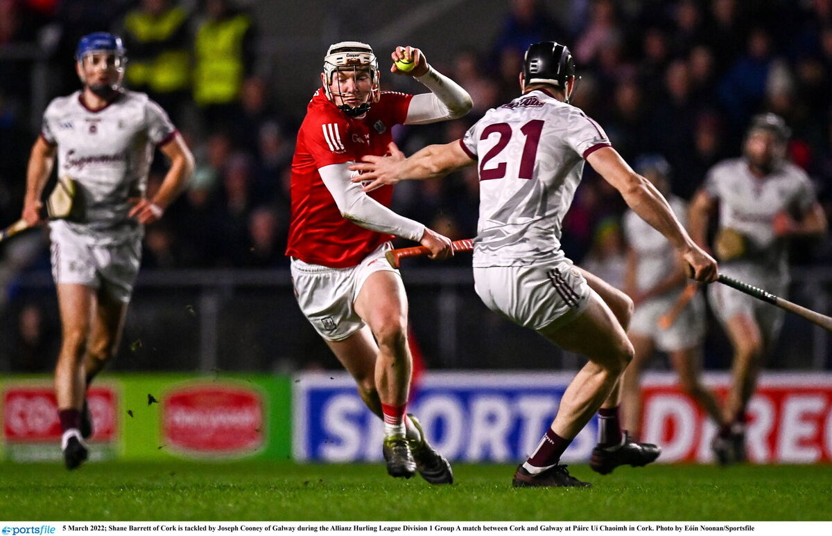 Shane Barrett of Cork is tackled by Joseph Cooney of Galway. Picture: Eóin Noonan/Sportsfile