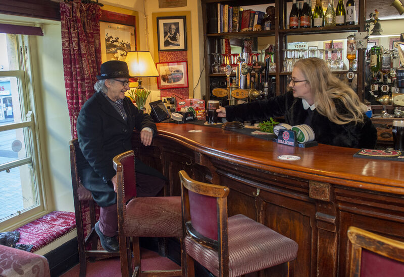  Rachel O'Donnell-Barry serving a pint to Hans Neff under the portrait of her late father Brian at the Hi-B on Oliver Plunkett Street. Picture: Dan Linehan