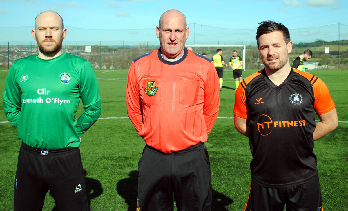 Cathedral Celtic's captain Darren Heaphy (right) with Blackpool Celtic captain Willie Matthews, accompanied by referee Richard O'Gorman.