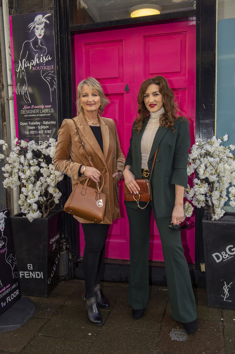 The women outside the pink doorway of the shop on Cook Street. The women outside the pink doorway of the shop on Cook Street.
