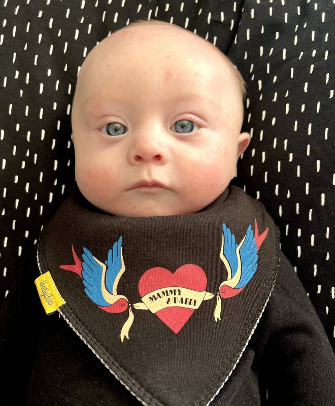 Gene Daly wearing one of the bibs his parents designed for Cork-founded company, Babyboo.ie. One euro from every bib sale will go to the Down Syndrome Centre.