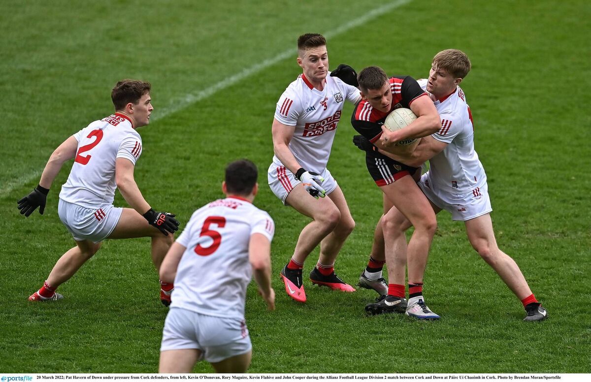 PRESS: Down's Pat Havern under pressure from Cork's Kevin O'Donovan, Kevin Flahive and John Cooper at Páirc Uí Chaoimh. Picture: Brendan Moran/Sportsfile