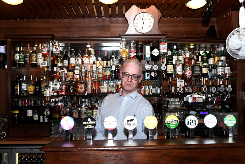 Rommel Horgan behind the bar, which has a large whiskey selection. Picture; Eddie O'Hare