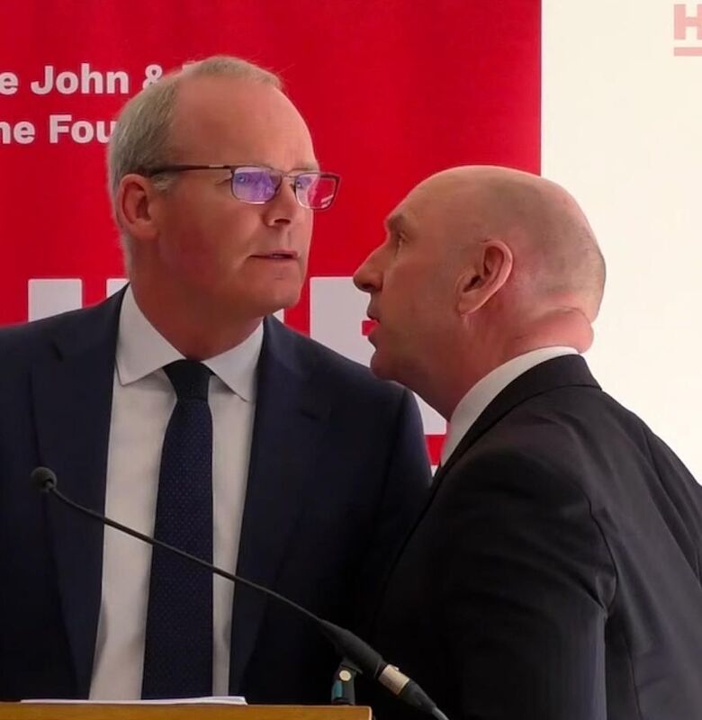 Screengrab taken from video issued by the Hume Foundation of Irish Foreign Affairs Minister, Simon Coveney, being ushered from the room due to a security alert whilst he was speaking at a peacebuilding event organised by the John and Pat Hume Foundation at The Houben Centre, Belfast.