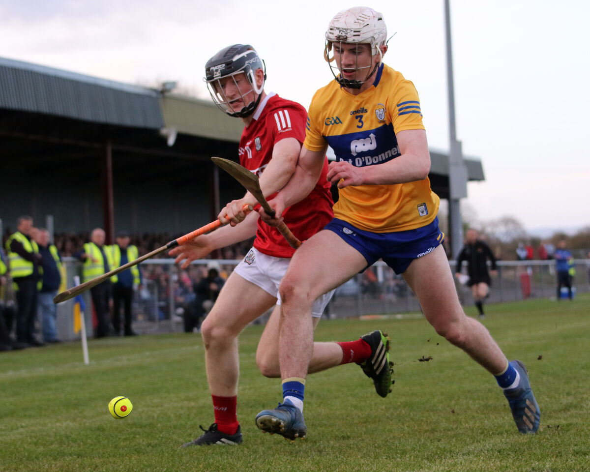Cork's Brian Keating battled Adam Hogan of Clare for possession in the oneills.com Munster U20 clash at Sixmilebridge. Picture: Brendan Gleeson