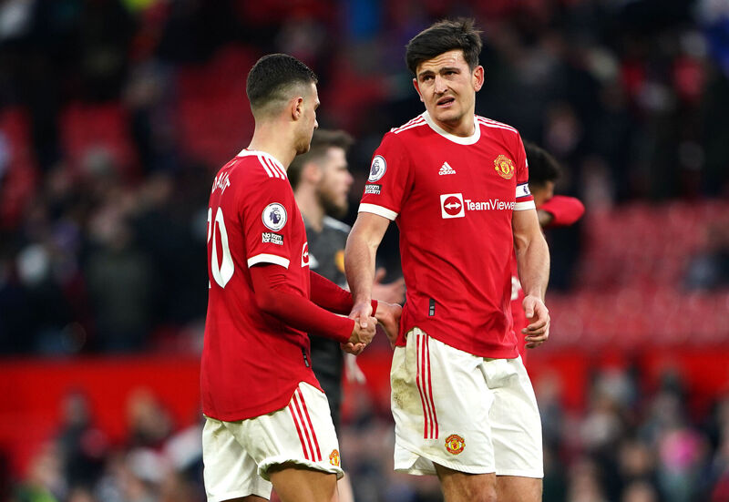Manchester United's Diogo Dalot and Harry Maguire react to a loss. Manchester United's Diogo Dalot and Harry Maguire react to a loss.