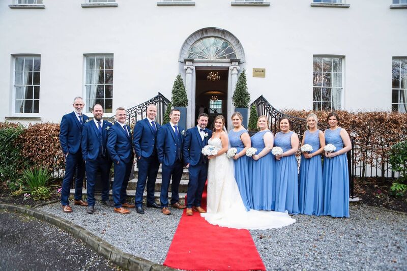 Sam and Troy with their wedding party, made up of family and friends. Sam and Troy with their wedding party, made up of family and friends.