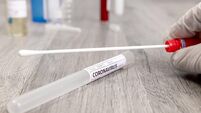 Cotton swab with tube labelled as Coronavirus