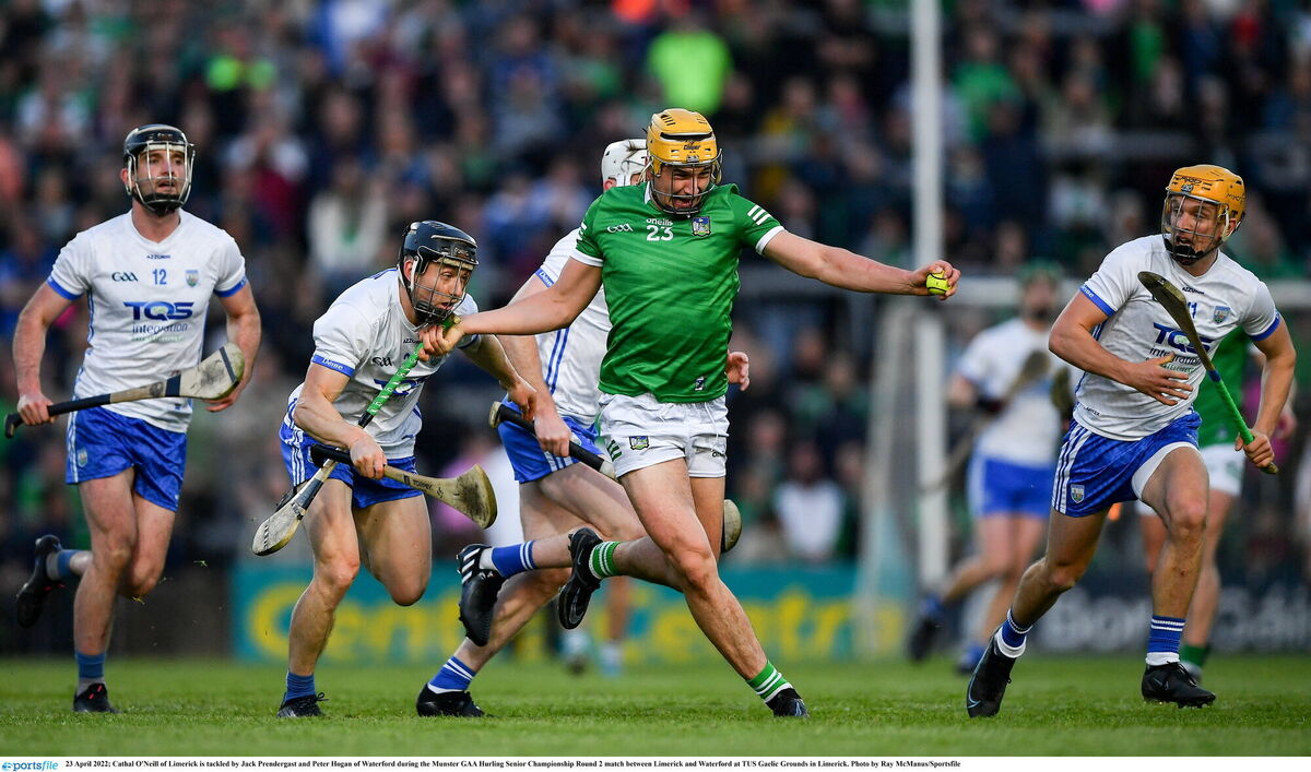 Cathal O'Neill of Limerick is tackled by Jack Prendergast and Peter Hogan of Waterford. Picture: Ray McManus/Sportsfile