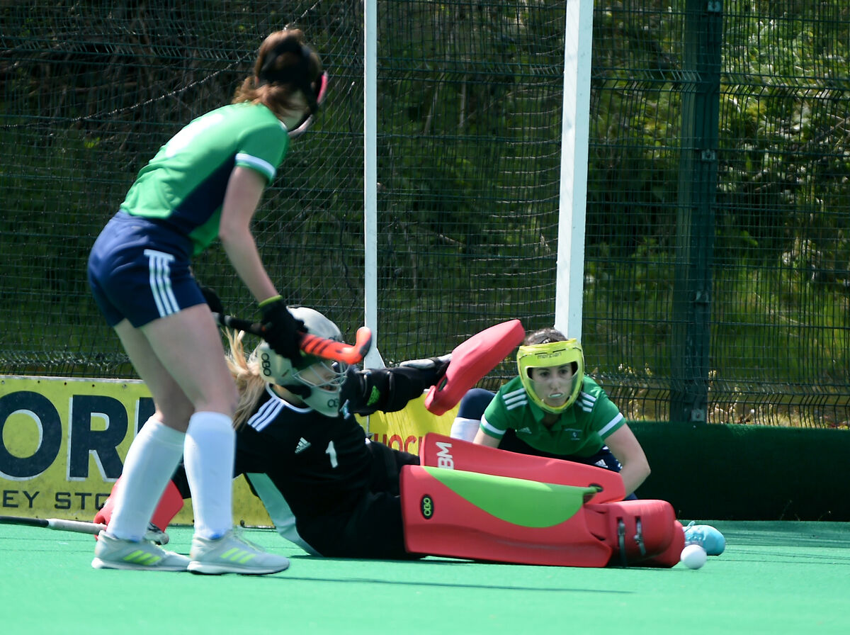 Church of Ireland goalkeeper Becky Maye gets down low to stop Ashton from scoring. Picture: Larry Cummins