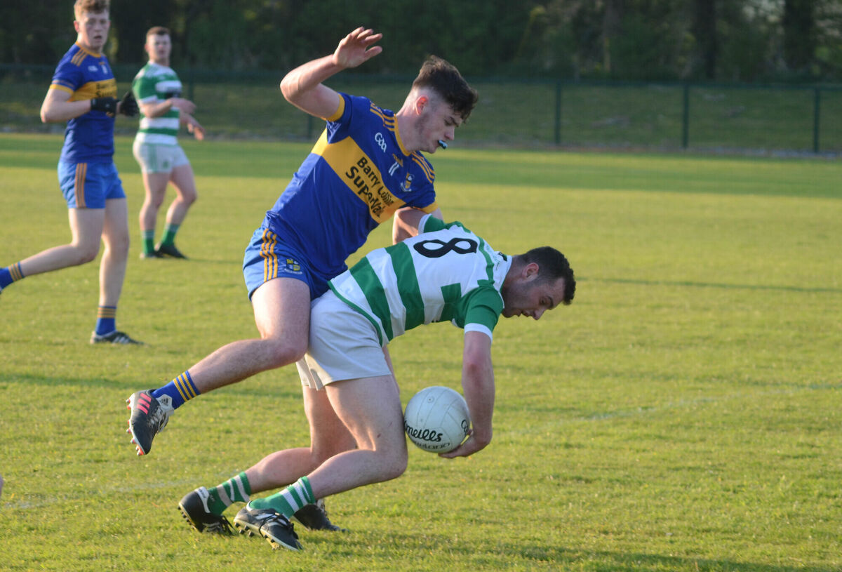 Valley Rovers Adam Kenneally stumbles to the ground as he is challenged by Carrigaline' Rhys McCarthy during the SE U21 A FC Final in Shanbally. Picture: Howard Crowdy