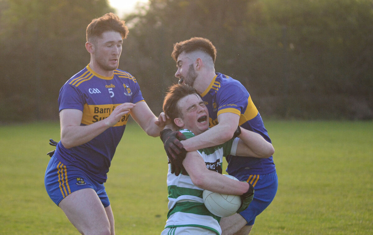 Valley Rovers Ciaran O'Shea feels the pain from Carrigaline's Tim Cronin and Callum Barrett's challenges during the SE U21 A FC Final in Shanbally. Picture: Howard Crowdy