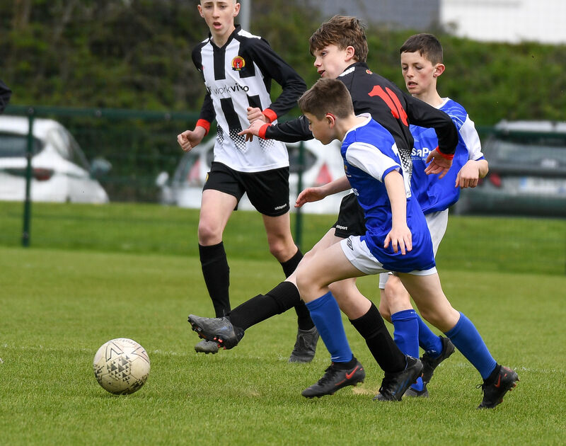  Midleton's Alfie Hennessy sets up an attack as Tullamore Town's Steven Murrihy closes in. Picture: David Keane.