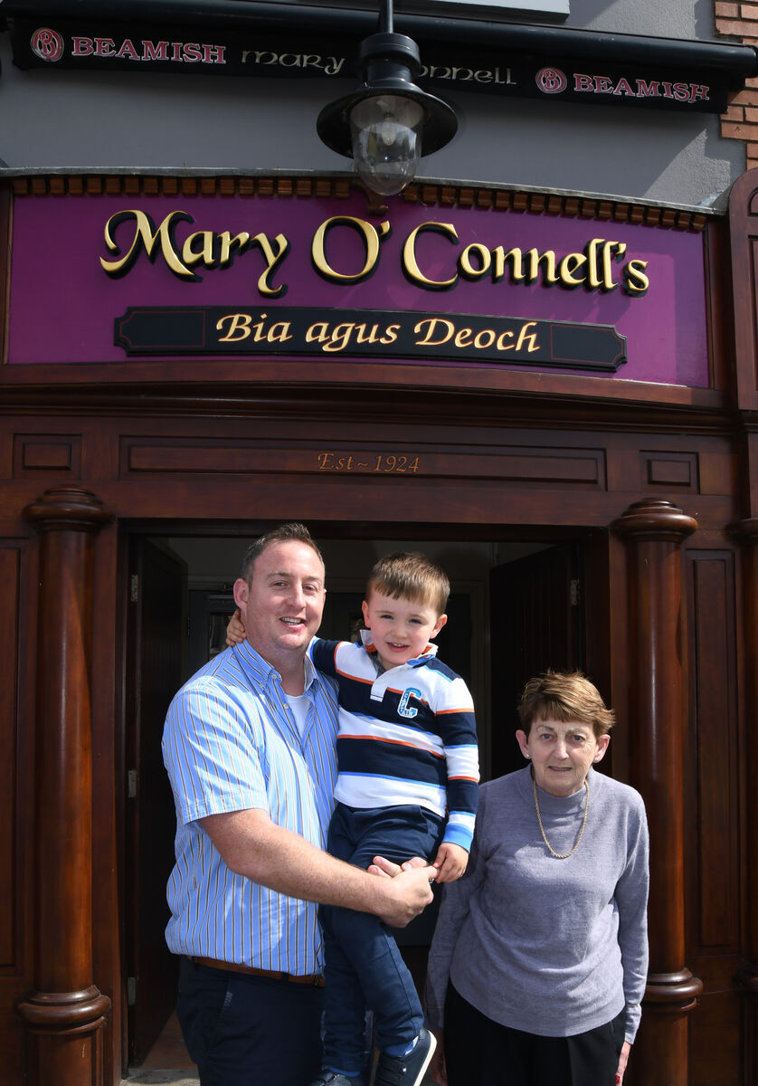 John Stevenson with his mother Joan and his son Jacob outside the family bar, Mary O'Connell's, Ballincollig. Pictures: Denis Minihane.