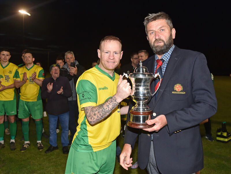 Munster Senior League chairman John Finnegan presents Rockmount captain Ken Hoey with the premier division trophy. Picture: Eddie O'Hare Munster Senior League chairman John Finnegan presents Rockmount captain Ken Hoey with the premier division trophy. Picture: Eddie O'Hare