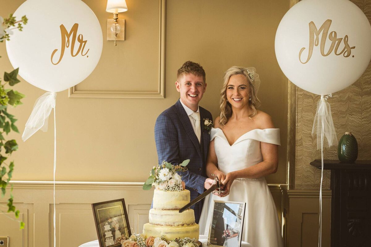 The happy couple with their wedding cake. The happy couple with their wedding cake.
