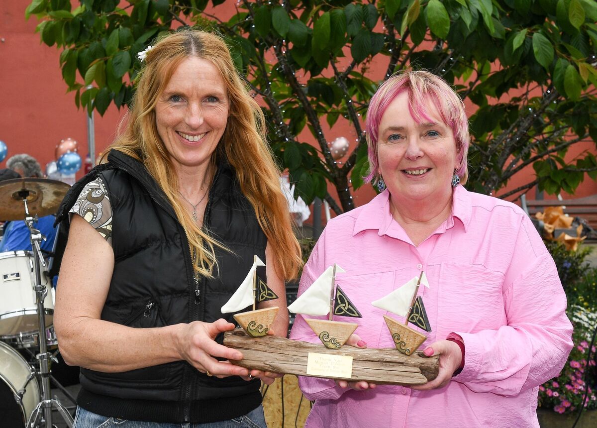  Assumpta Lydon, right, representing Passage West Community, making a special presentation to Cllr Marcia D'Alton, during the street party in Passage West.