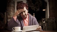 Distressed Senior Woman with Bills