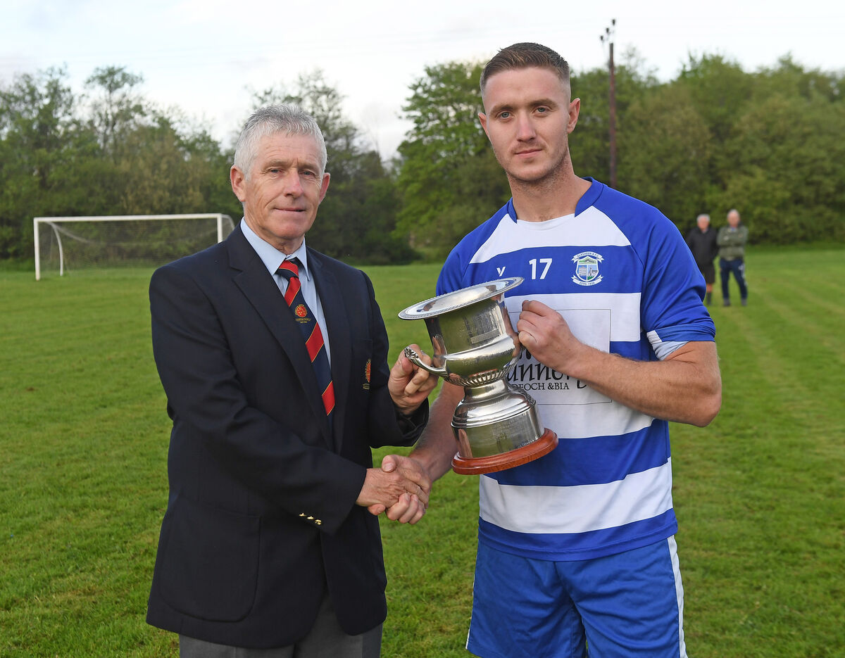 John Lyne, Munster senior league presents the Beamish Stout Junior Second Division trophy to Declan O'Flaherty, captain of Glasheen at Murphy's Farm. Picture; Eddie O'Hare