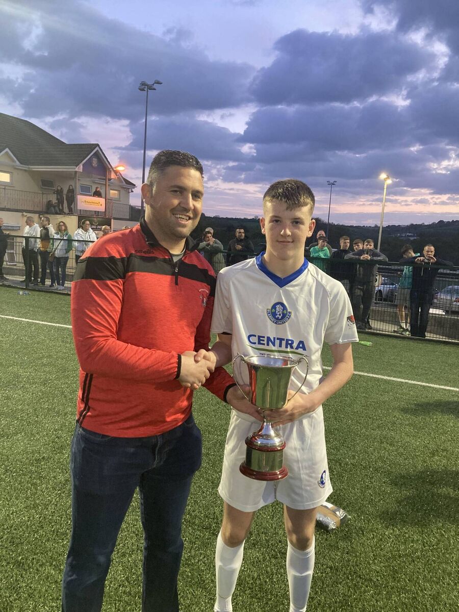 James Fogarty of the Cork Youth League presenting the cup to Blarney United captain Dan Murphy.