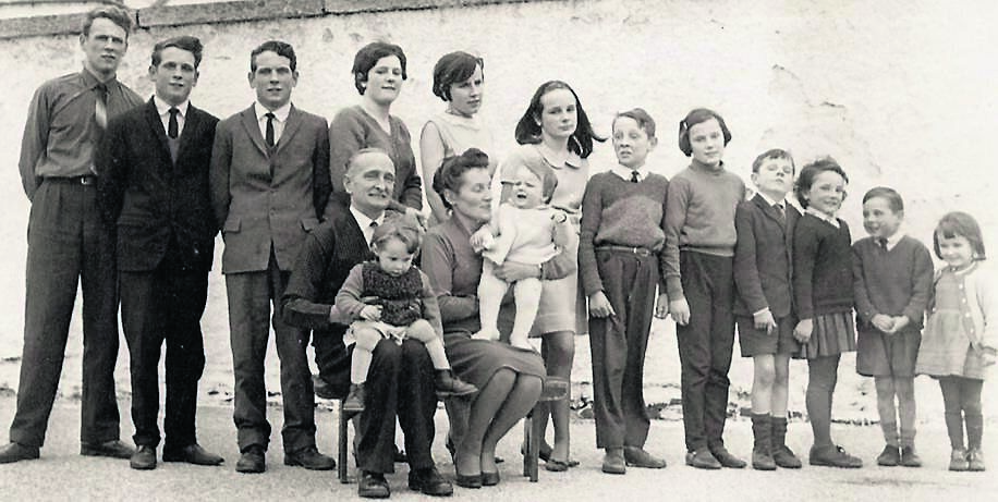 Pauline and Larry Butler with 14 of their 15 children, who were raised in lighthouses.