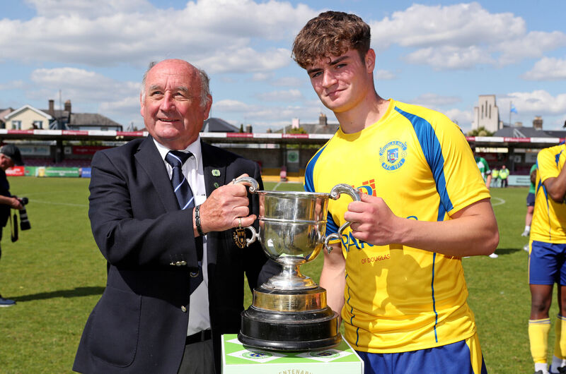  Richard Browne, Munster Football Association, presents the Cup to Gavin O'Shea, Douglas Hall Captain. Munster Youth Cup Final, Douglas Hall V's Villa FC.