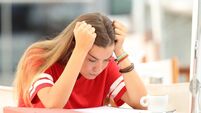 Frustrated student trying to understand notes in a bar