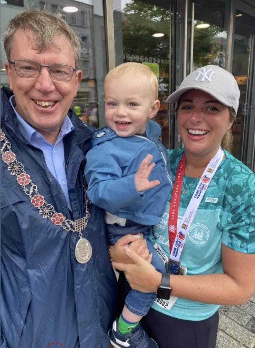 Michelle Fitzgerald celebrates with her dad, Cllr Tony Fitzgerald, who was deputising for the Lord Mayor, and her nephew Eoin White, after taking part in the Cork City Marathon and Relay.